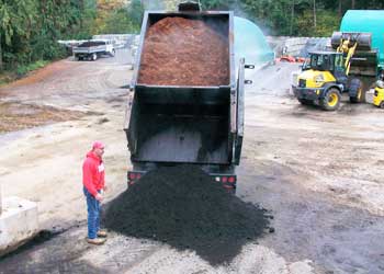 truck dumping out topsoil